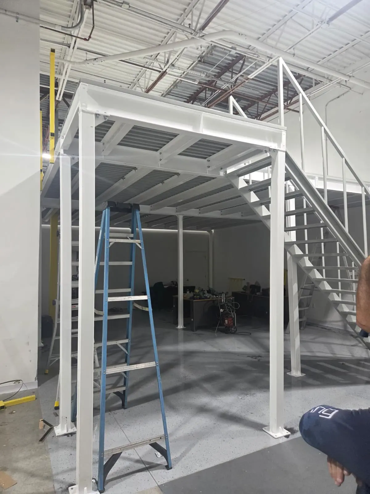 Steel columns and support beams for a multi-tiered mezzanine floor